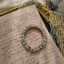 The "River of Captured Starlight," a vintage Trifari three-row tennis bracelet, featuring perfectly matched, brilliant-cut clear Austrian crystal rhinestones.
