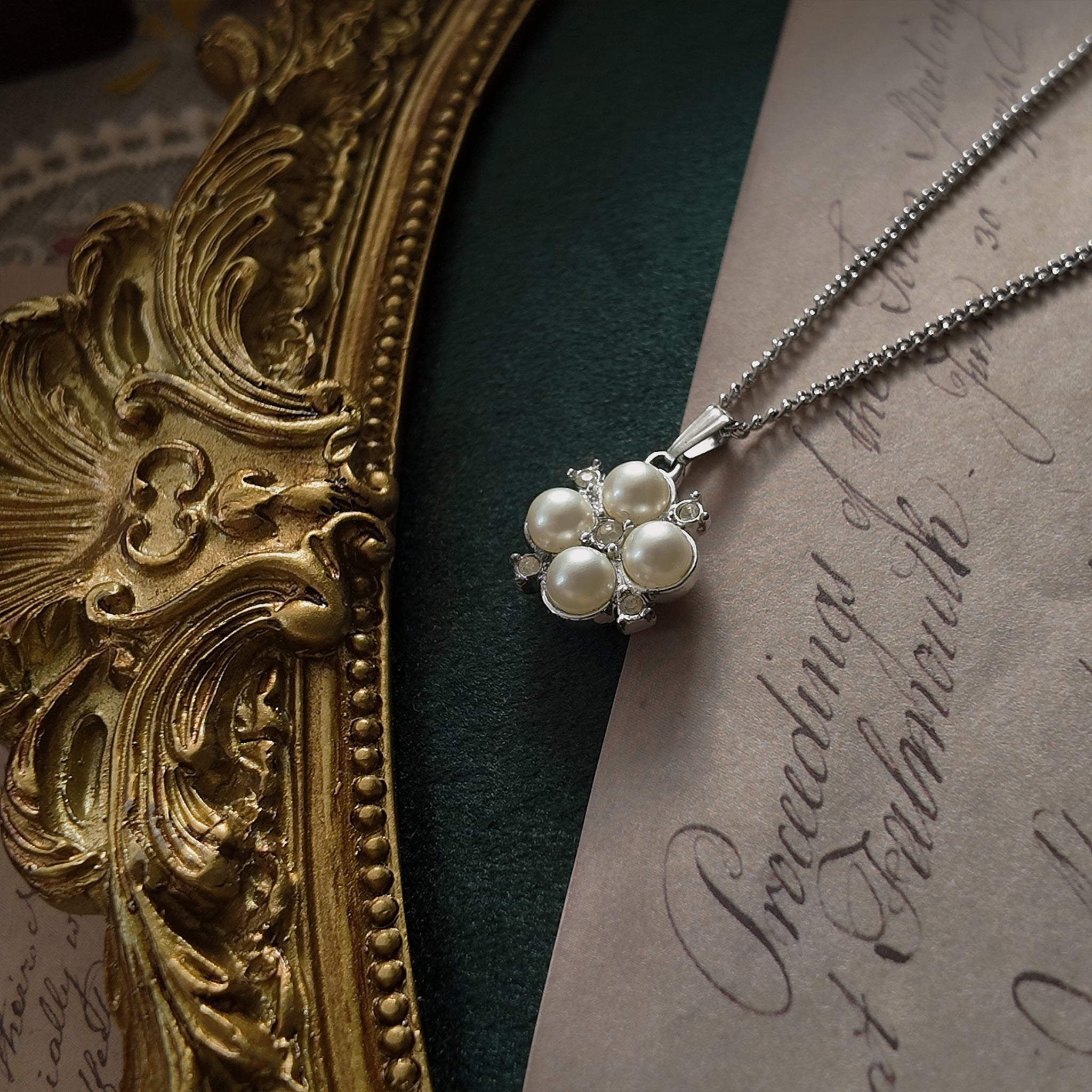 The Sarah Coventry "X" pendant necklace worn on the neck, serving as a symbol of self-love and a piece of defiant, unconventional bridal jewelry.