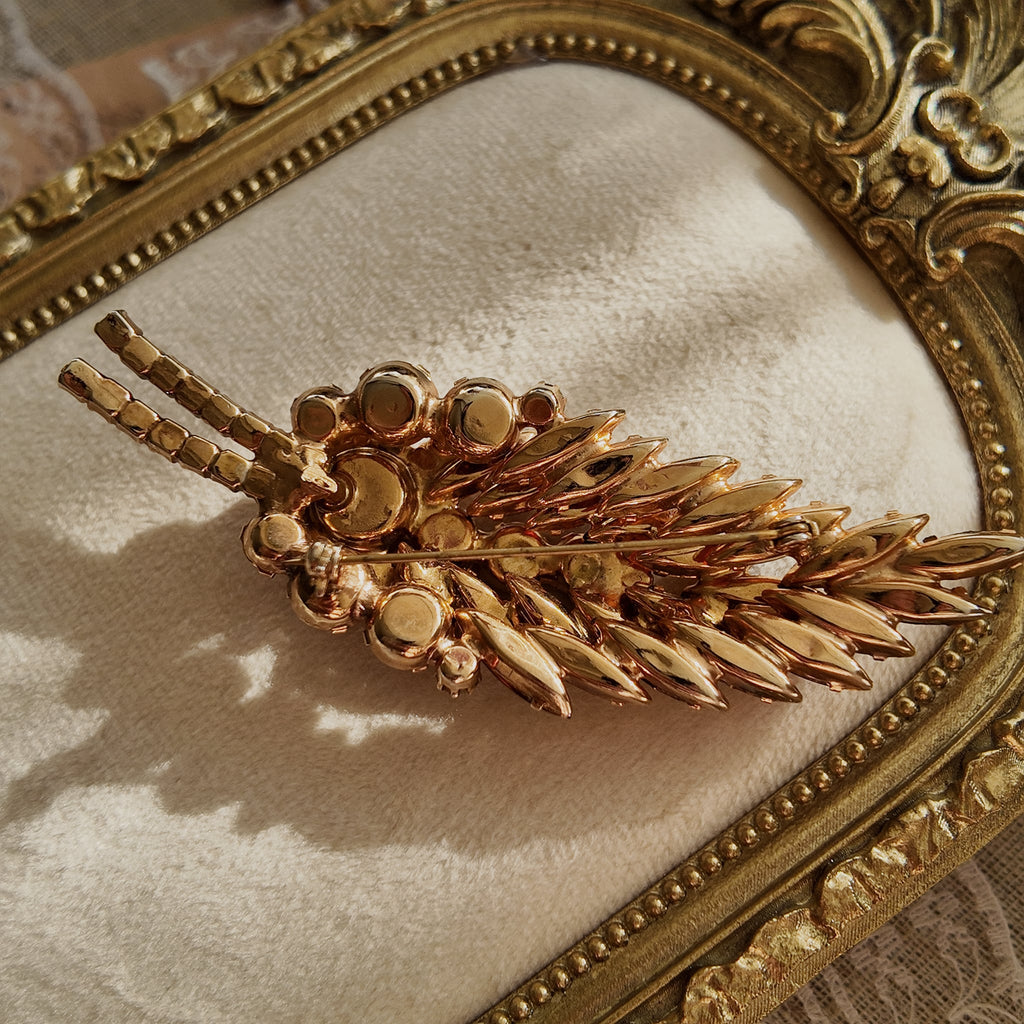 The reverse side of the unsigned Juliana brooch, showing the characteristic open-back settings and puddling solder that confirm its DeLizza & Elster origin.