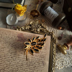 The reverse side of the unsigned Juliana brooch, showing the characteristic "puddling" solder and construction that authenticates it as a DeLizza & Elster piece.