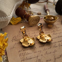 The reverse side of the mint condition vintage earrings, showing the clean, high-quality construction and the secure clip-on mechanism.