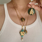 A woman wearing the Green Aventurine leaf pendant, showcasing its bold statement size and its identity as a piece of sustainable, vintage-style jewelry.
