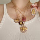 A woman wearing the elegant Rose Quartz leaf pendant, showcasing its statement size and the beautiful contrast between the **vintage brass** and the soft pink stone.