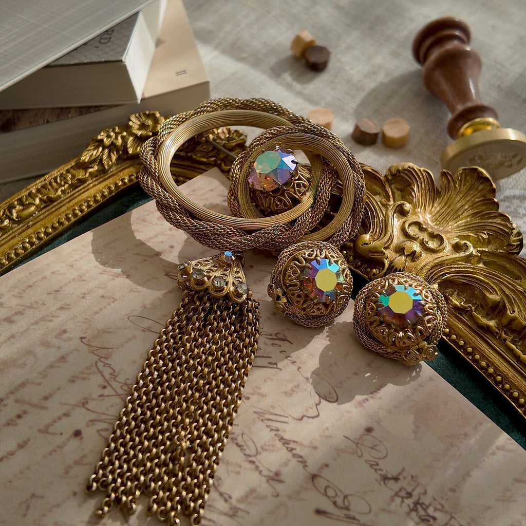 A macro shot honestly detailing the visible surface scratches on the large Aurora Borealis crystal of the Vendôme brooch, sold as-is for its design integrity.