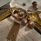 A macro shot honestly detailing the visible surface scratches on the large Aurora Borealis crystal of the Vendôme brooch, sold as-is for its design integrity.