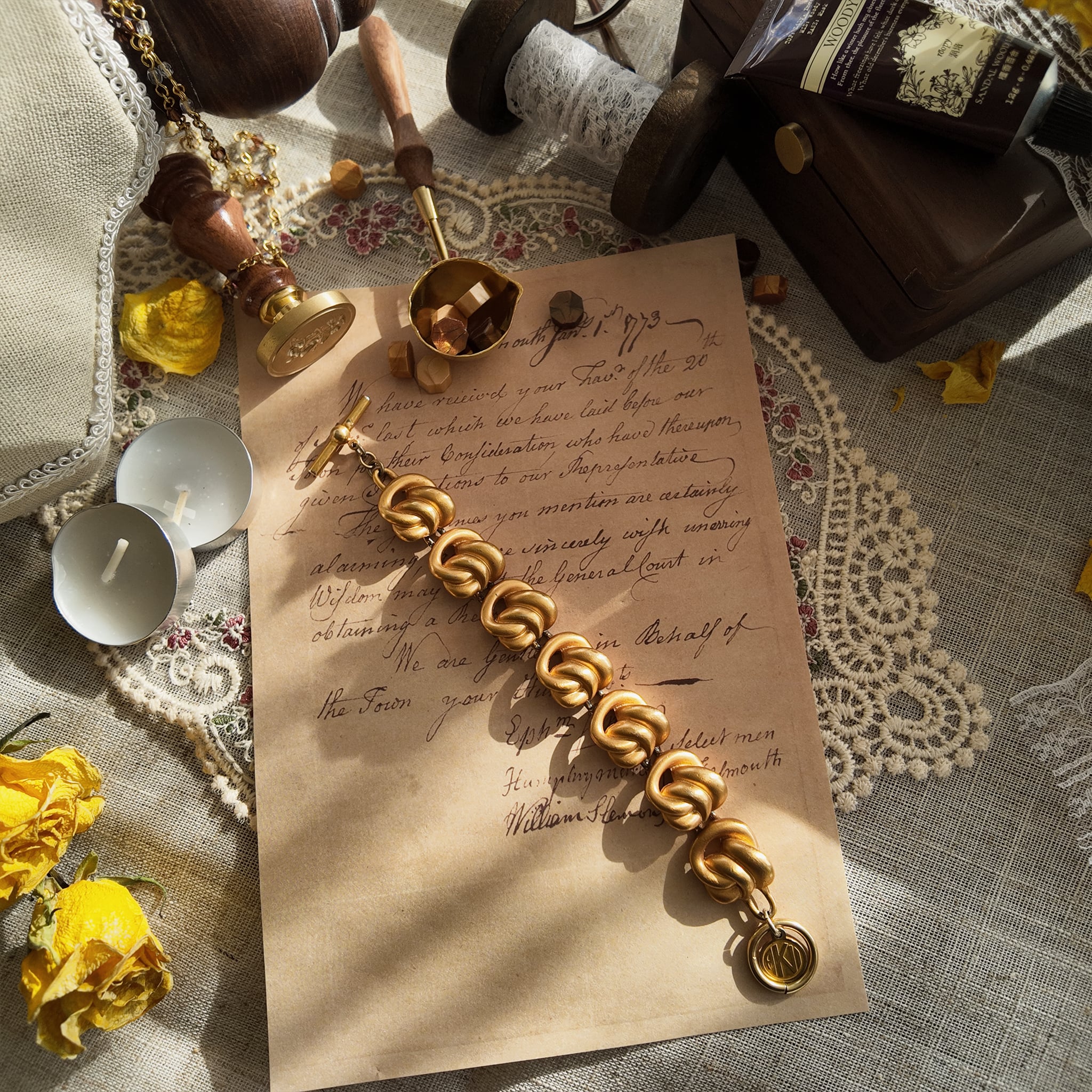 The "Corner Office," an iconic 1980s vintage Anne Klein jewelry set, featuring a substantial matte gold knot bracelet and matching clip-on earrings.