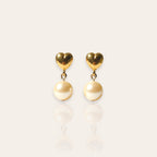The "Daily Dose of Darling," a pair of vintage Avon dangle earrings, featuring a polished gold-tone heart stud with a single, dangling faux pearl.