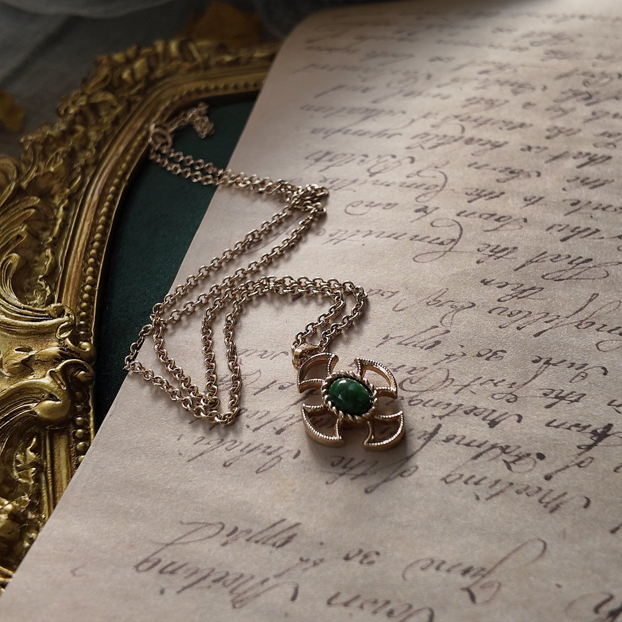 The "Pocketful of Daydreams," a vintage Avon necklace featuring a rose gold-tone, engraved heart pendant with a tiny central red rhinestone