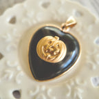 Close-up detail of the vintage brass Jack-o'-Lantern face, showcasing its classic mischievous expression on the black onyx.