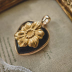 Close-up detail of the vintage brass poppy flower in full explosive bloom with warm rich tones.