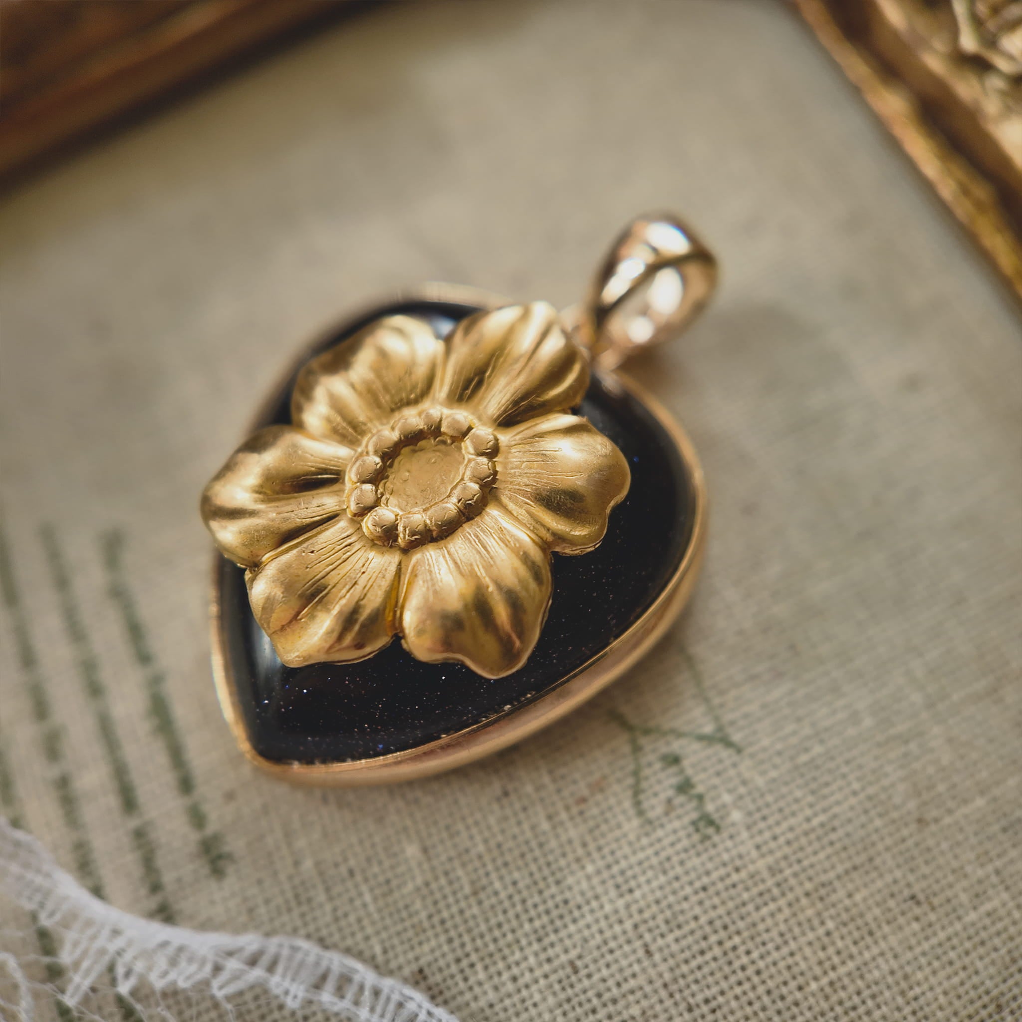 Close-up detail of the vintage brass poppy flower in full explosive bloom with warm rich tones.
