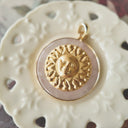  Close-up detail of the vintage brass "Sun Face" motif, showing the serene human expression and classic celestial design.