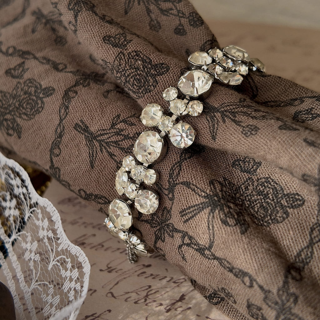 The delicate Weiss rhinestone bracelet worn on a wrist, showcasing its beautiful drape and how it catches the light to create an effortless, everyday sparkle.