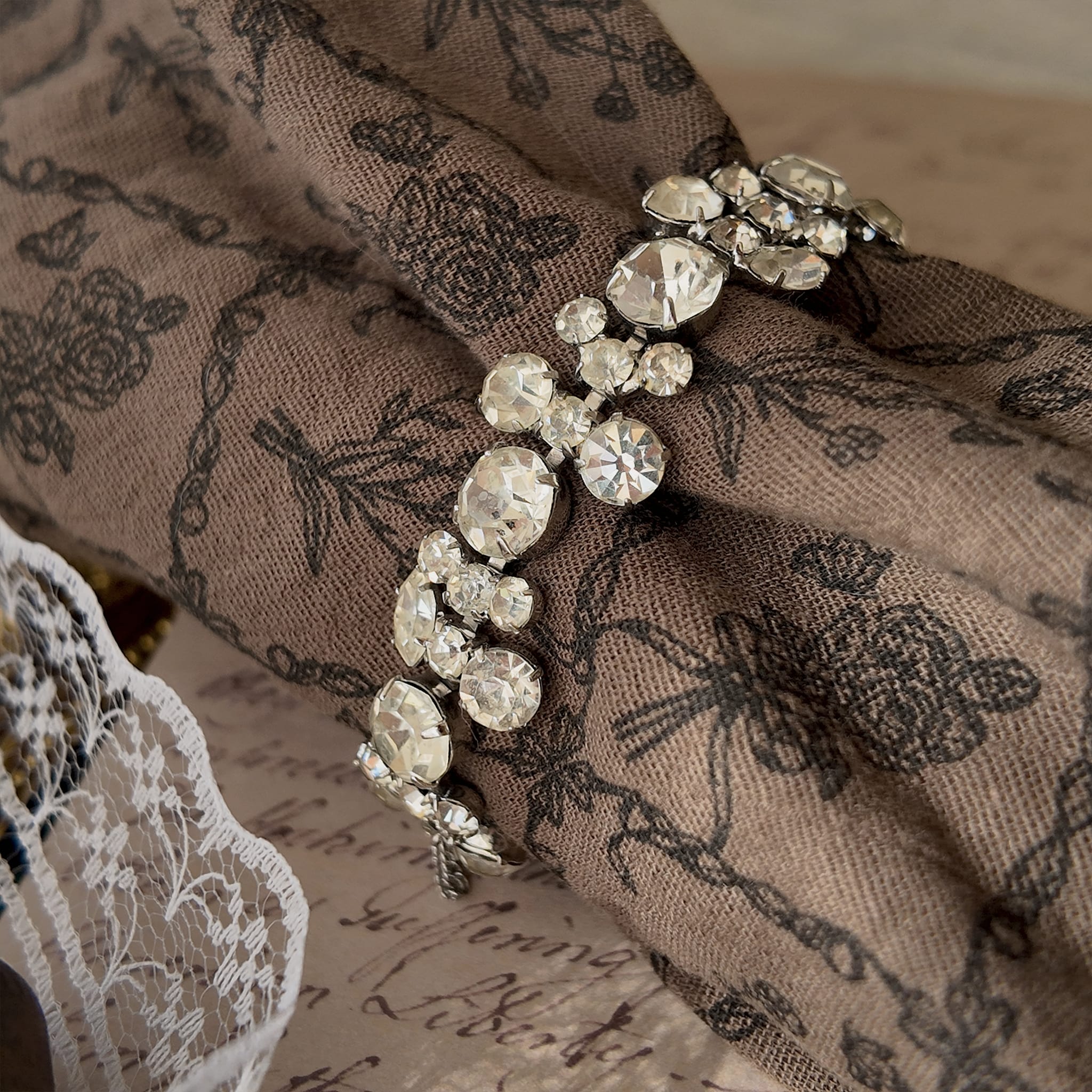 The delicate Weiss rhinestone bracelet worn on a wrist, showcasing its beautiful drape and how it catches the light to create an effortless, everyday sparkle.