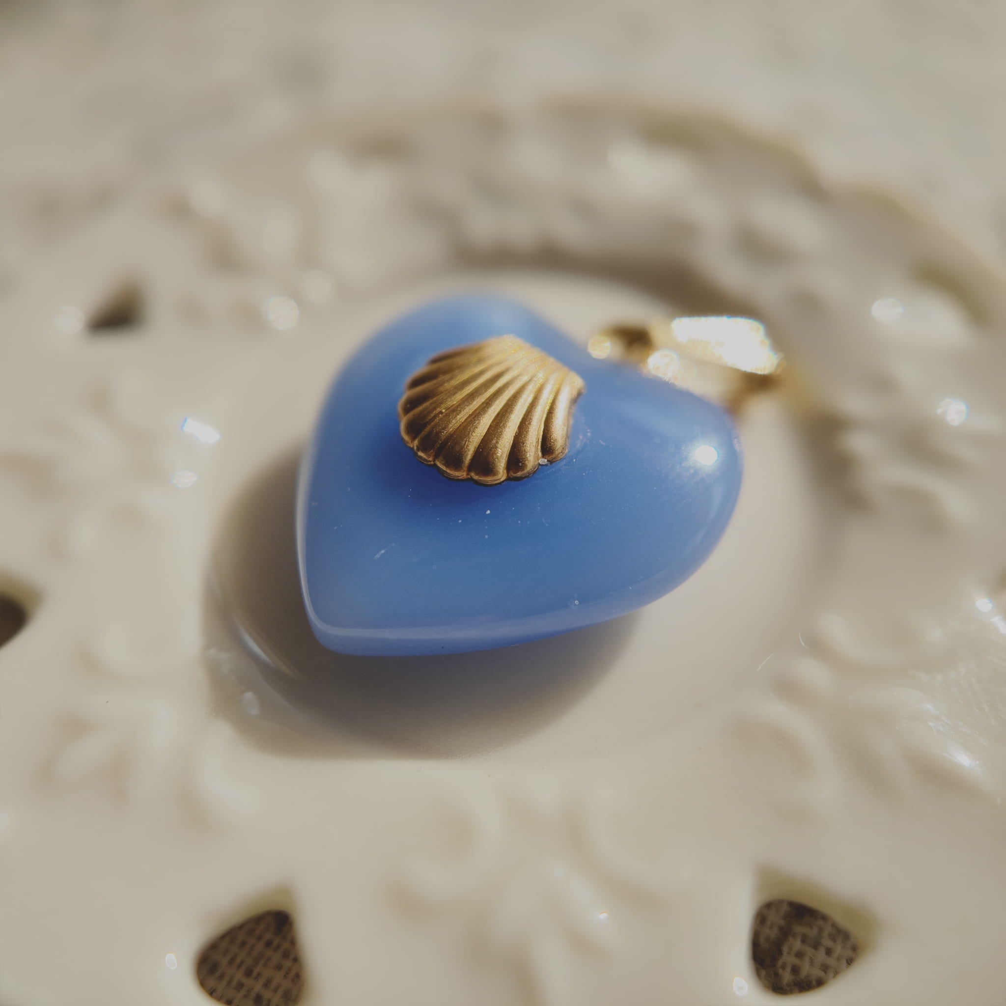 Texture detail of vintage lake blue art glass, showcasing its uniform opaque hue and smooth finish, resembling polished sea glass.