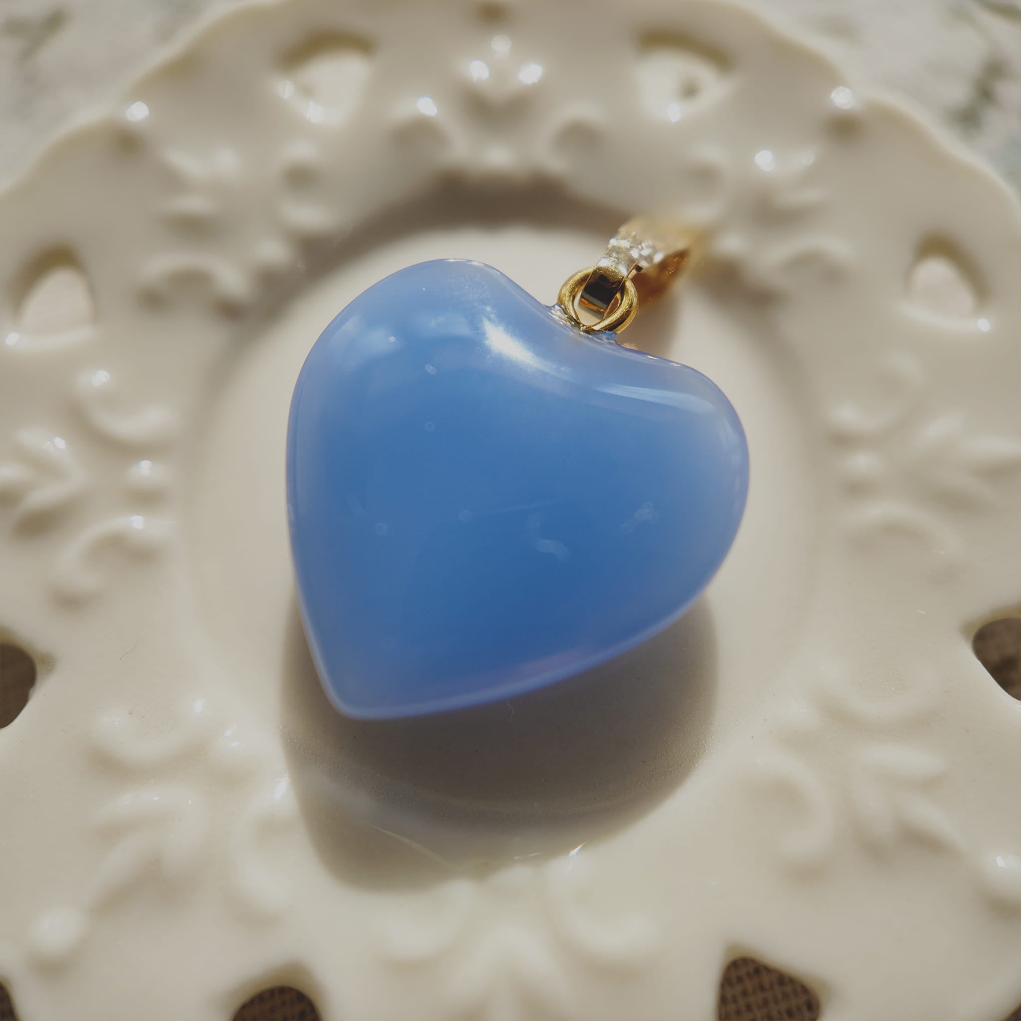 Texture detail of vintage lake blue art glass, showcasing its uniform opaque hue and smooth finish, resembling polished sea glass.