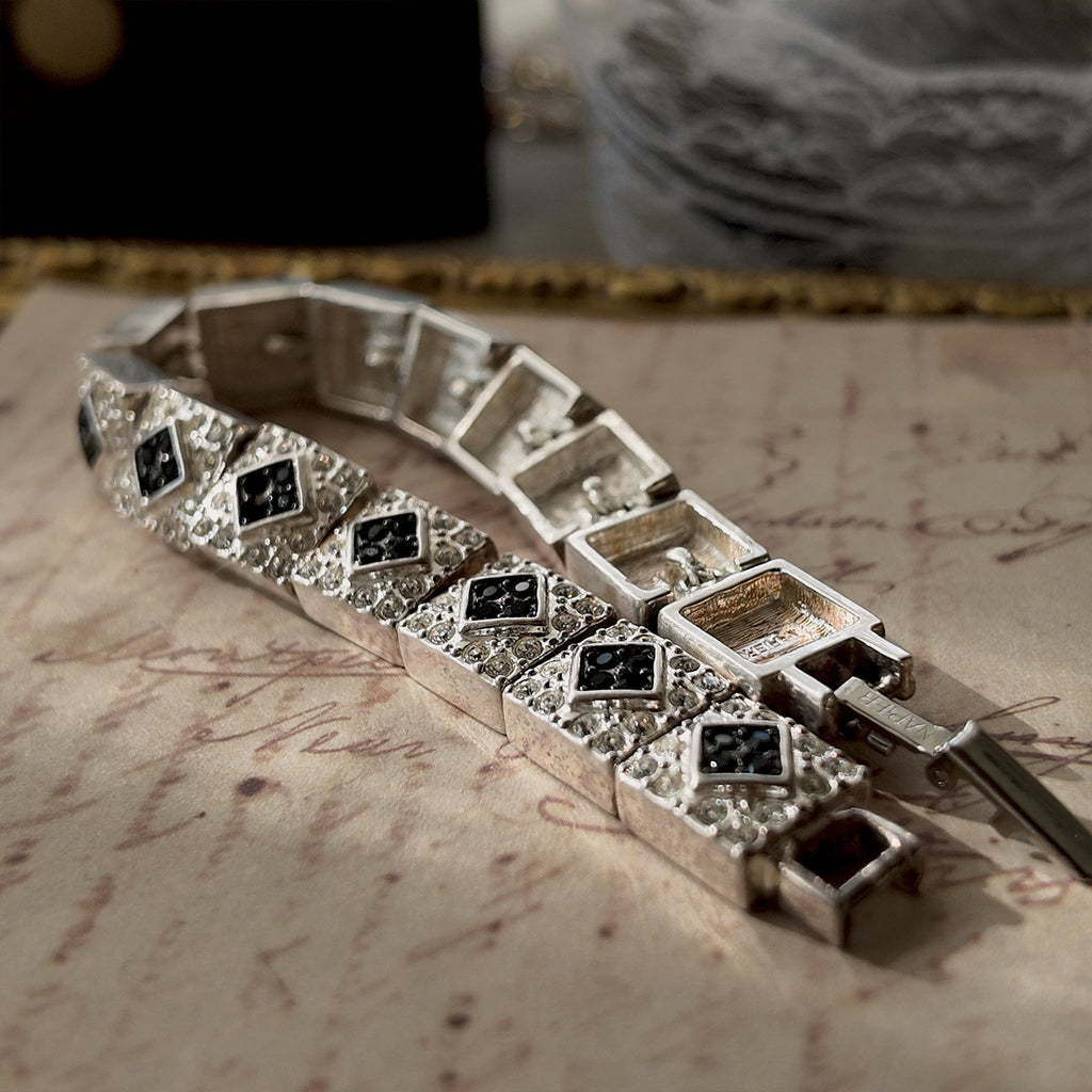 An angled view of the "Flapper Architect" bracelet, highlighting the excellent condition of the front face and the intense fire of the clear and black crystals.