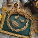 The Napier golden leaf piece shown in its full necklace form, a graceful 14-inch choker made of interconnected, brushed gold leaves.