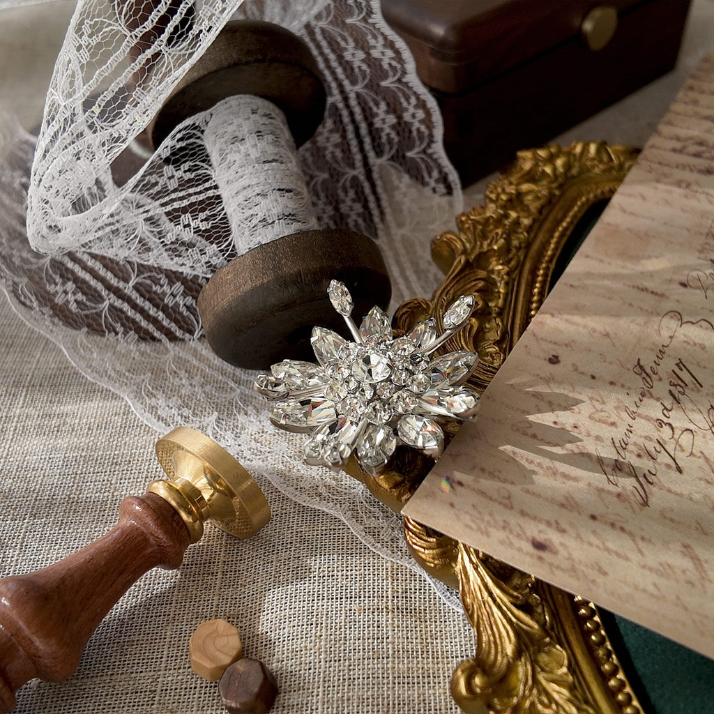 The Original by Robert statement pin worn on a black velvet dress, showcasing its spectacular sparkle, making it a perfect piece of vintage bridal jewelry.