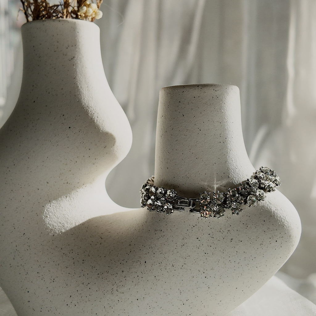 The substantial Trifari crystal bracelet worn on a wrist, showcasing its elegant drape and the incredible, diamond-like sparkle that defines "Quiet Luxury" aesthetic.