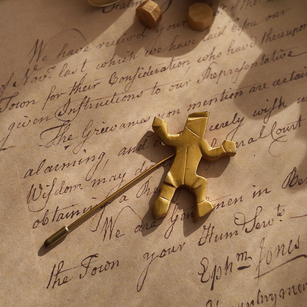 A detailed photo honestly showing the minor, visible plate loss on the sharp edges of the Van Wyk brooch, a sign of its authentic, well-lived history.