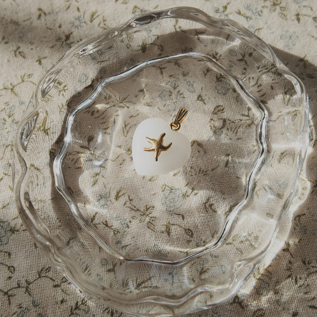 Atmospheric flatlay photography of the vintage component necklace, styled to evoke warmth, ocean vibes, and coastal serenity.