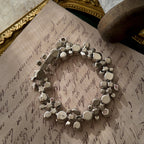 A close-up of the authentic "WEISS" signature on the clasp, also honestly showing the visible scuffs and wear on the back of the vintage bracelet.