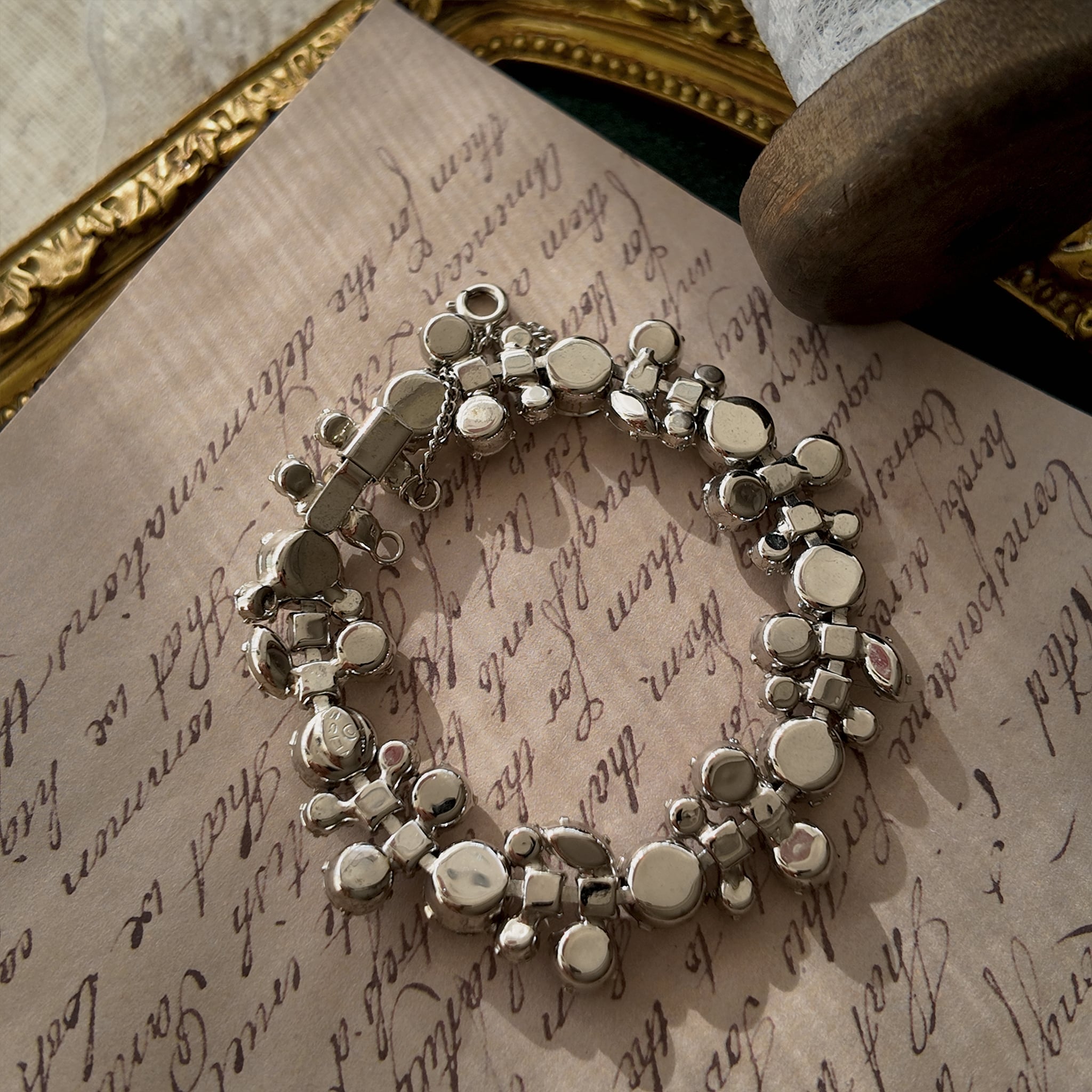 A close-up of the authentic "WEISS" signature on the clasp, also honestly showing the visible scuffs and wear on the back of the vintage bracelet.