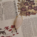 The reverse side of the upcycled White Quartz charm, showing the beautiful, natural internal mists visible through the semi-translucent stone.