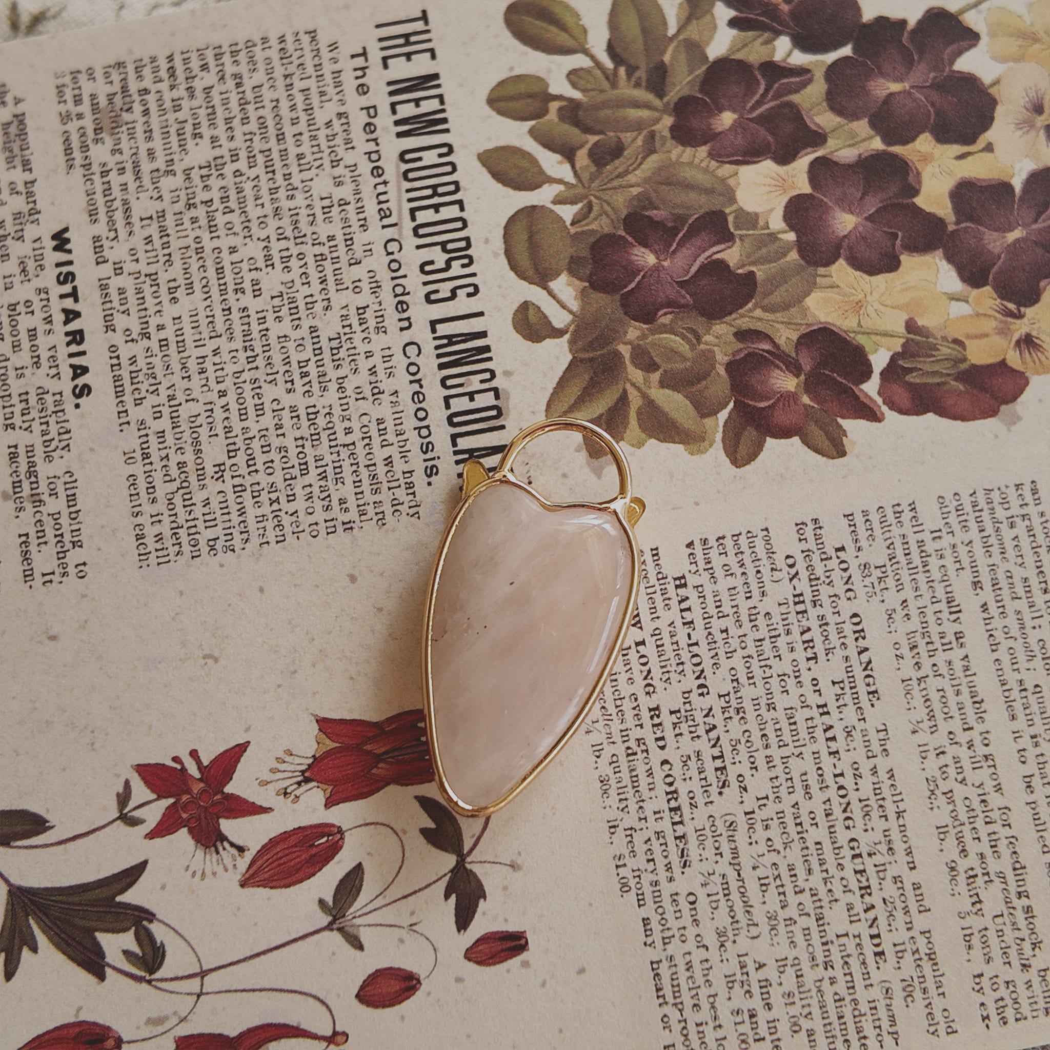 The reverse side of the upcycled White Quartz charm, showing the beautiful, natural internal mists visible through the semi-translucent stone.