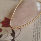 The reverse side of the upcycled White Quartz charm, showing the beautiful, natural internal mists visible through the semi-translucent stone.