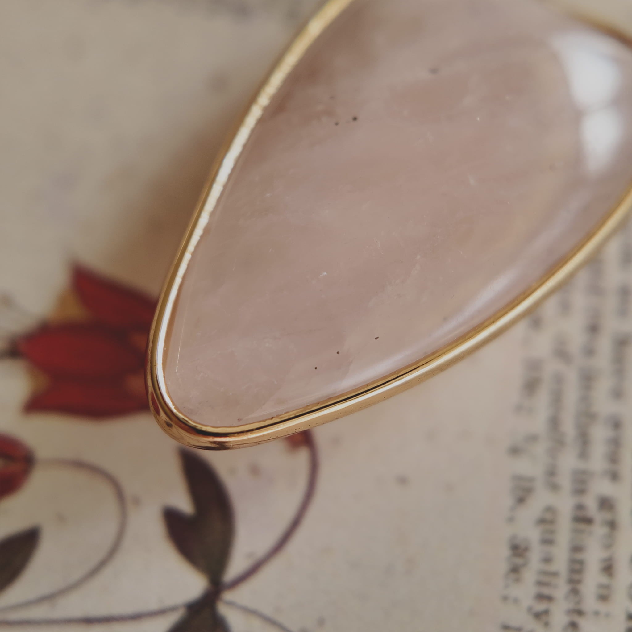 The reverse side of the upcycled White Quartz charm, showing the beautiful, natural internal mists visible through the semi-translucent stone.