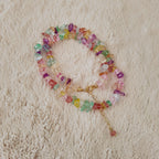 The stone chip necklace styled as a layering piece with a gold chain, demonstrating its versatility and its role in the "Dopamine Dressing" trend.