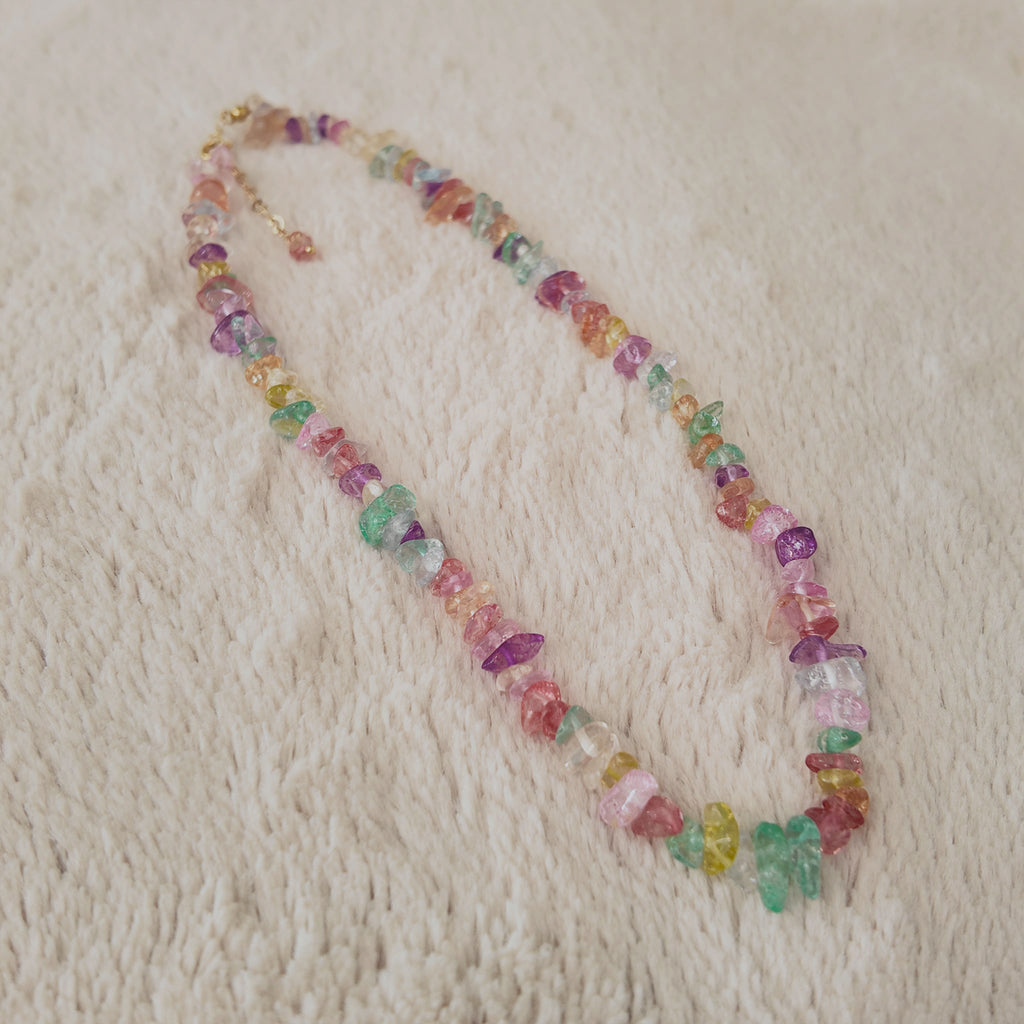 The "Endless Summer," a vibrant, artisan-made Y2K style beaded necklace, featuring a rainbow of multi-colored, polished natural stone chips.