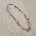 The "Endless Summer," a vibrant, artisan-made Y2K style beaded necklace, featuring a rainbow of multi-colored, polished natural stone chips.