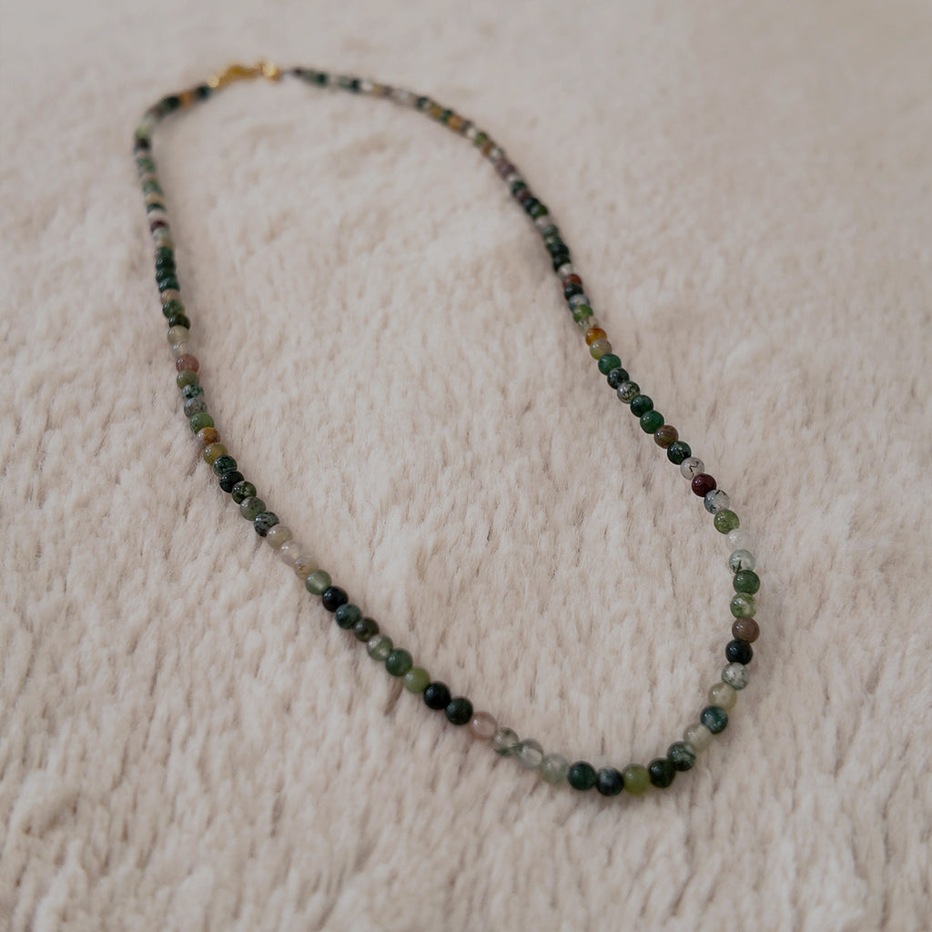 The "Quiet Path" agate necklace styled with a ceramic tea cup to emphasize its "Oriental Zen" and "Forest Core" aesthetic, a true breath of fresh air.